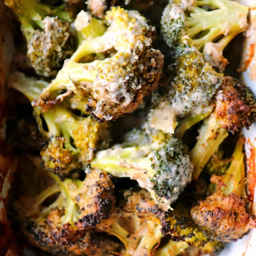 A huge pile of roasted broccoli, crispy and slathered in NONA Alfredo sauce.